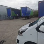 A picture of the front of our van onsite with other large haulage trucks